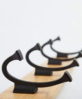 Heavy Duty Wall Mount Coat Rack With Seven Rugged Zinc Hooks For A Slick Entryway And No Sweat Organization Of Puffer Jackets Gym Towels And Baseball Caps, close-up of zinc hooks on a wooden base.