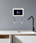 Heavy Duty Instant Electric Water Heater Delivers 3000W Turbo Heat And Kickin Hot Water Through A No Fuss Wall Mount Build Featuring A Slick Digital Touch Screen Panel on wall with faucets.