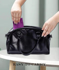 PerfectSight microfiber cleaning cloth, purple, placed into a black handbag.