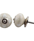 One Hundred Piece Ceramic Drawer Knobs In Warm Dotted Cream Decorative Kitchen Cabinet Hardware And Dresser Door Pulls close-up of shiny cream ceramic knob with silver base