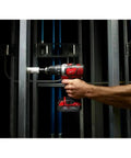 Person using Top Shelf Cordless Drill Driver Combo Pack with all metal gears on a metal frame at job site.
