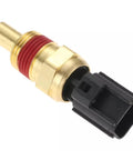 Side view: engine coolant temperature sensor with brass body and red thread sealant, black plastic connector.