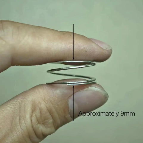 Close-up of a hand holding part of the 2 Pack Mountain Bike Ratchet Hub Wave Spring Upgrade Kit, showing approximately 9mm height.