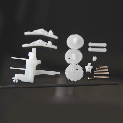 Mini Ornithopter Shaft With Ornithopter Mechanism Kit Components laid out showing gears and rods for power transmission
