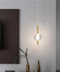 Nordic Minimalist Pendant Light With Crystal Glass Shade, Adjustable Mini Ball Design, modern metal base in living room setting.