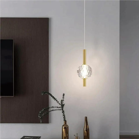 Nordic Minimalist Pendant Light With Crystal Glass Shade, Adjustable Mini Ball Design, modern metal base in living room setting.