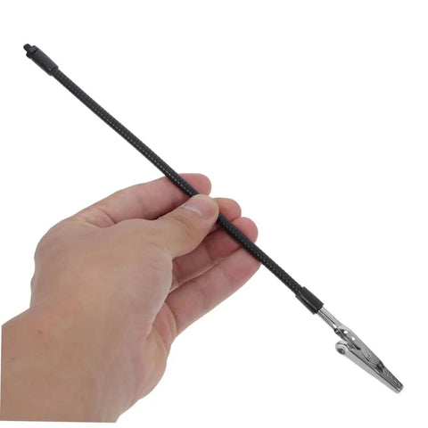 Hand holding flexible gooseneck holder of Adjustable Soldering Arm With Magnifying Glass And Lamp Clamp Handy Multi Tool For Welding And Electronics Workstation.