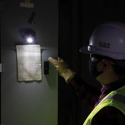 Worker using Rechargeable Two Color LED Headlamp With Durable Fabric Strap, Spotlight And Floodlight Modes, indoor setting.