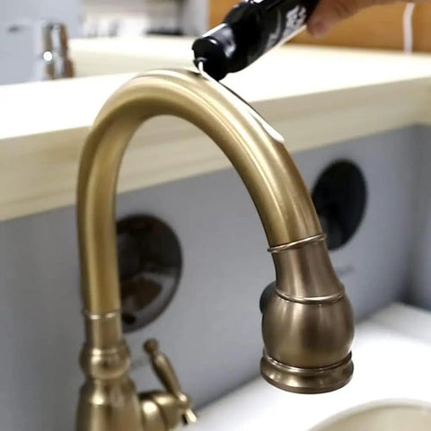 Applying Faucet Wax Plus 7.6oz USA Made Water Based Cleaner and Polish on a bronze faucet to remove water stains and fingerprints.