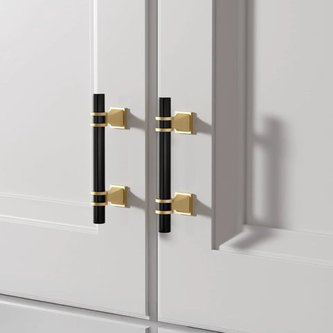 10 Pack 3 Inch Hole Center Cabinet Handles In Black And Gold Matte Finish, 5 Inch Overall Length, installed on white doors