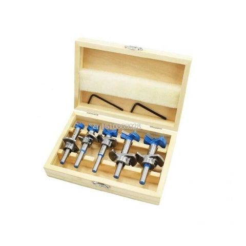 Five-piece Forstner drill bit set in a light wooden storage box with blue collars.
