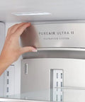 Hand installing PureAir Ultra II filter in refrigerator, part of Plug And Play PureSource Ultra Water And Air Filter Kit With PureAir Ultra II And PureFresh Replacements For Home Use Easy Install Long Lasting Fresh Water And Clean Indoor Air.