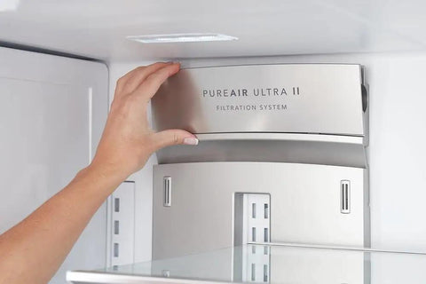 Hand installing PureAir Ultra II filter in refrigerator, part of Plug And Play PureSource Ultra Water And Air Filter Kit With PureAir Ultra II And PureFresh Replacements For Home Use Easy Install Long Lasting Fresh Water And Clean Indoor Air.