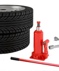 Rock Solid Vertical Hydraulic Bottleneck Jack For Cars 5 To 10 Ton Capacity Red with tires and tools, compact, garage essential.