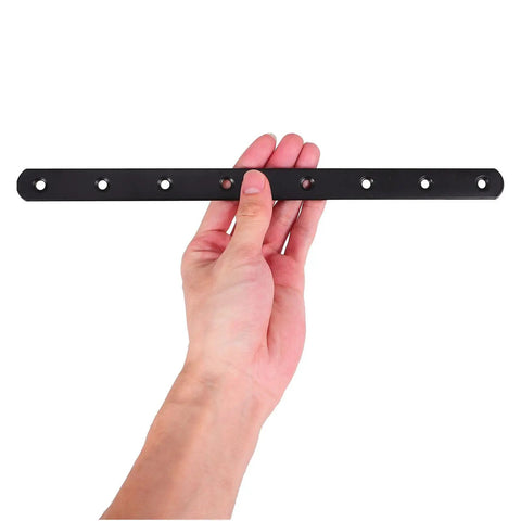 Hand holding heavy duty black stainless steel flat straight bracket for furniture repair and shelf support with countersunk holes.