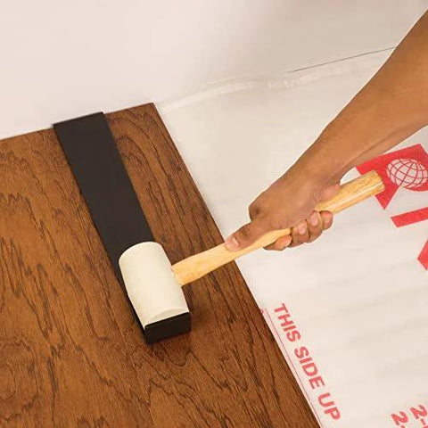 Using Pro Pull Bar 16.25 Inch Long With Three Inch Pull Edge on wood floor with hammer for tight seams