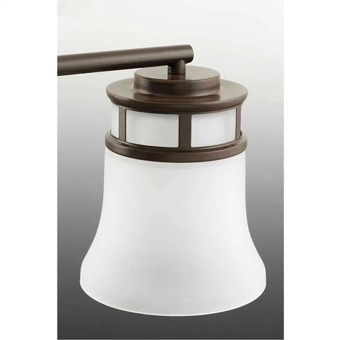 Close-up of Coastal Five Light Chandelier with etched glass shade in antique bronze, part of modern gas light look pendant light.