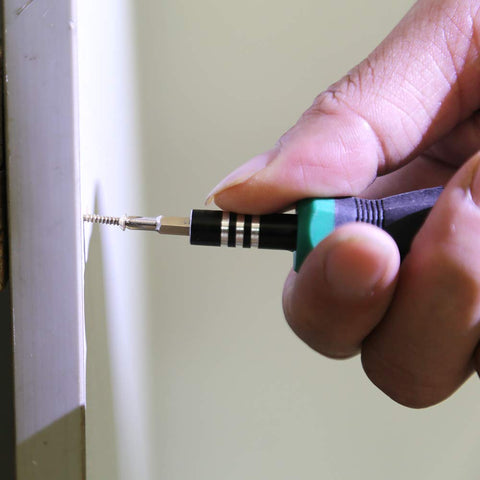 Close-up of installing screw from 1600Pcs 2mm Phillips Flat Head Self Tapping Tiny Screws Set for DIY Woodworking and Electronics Cabinets