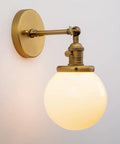 Vintage Wall Sconce Lighting Fixture With 5.9-Inch Round Milk White Hand Blown Glass Globe Shade Hardwired Mount Antique Brass Finish With Switch Compatible With E26 Base Bulbs Dimmable showing side view.