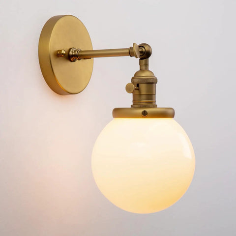 Vintage Wall Sconce Lighting Fixture With 5.9-Inch Round Milk White Hand Blown Glass Globe Shade Hardwired Mount Antique Brass Finish With Switch Compatible With E26 Base Bulbs Dimmable showing side view.