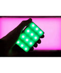 Person holding Amaran MC RGBWW Mini On Camera Light With 3200K To 6500K CCT CRI TLCI 96 HSI Color Control 360 Degree Hue And 100 Levels Saturation