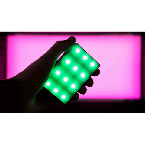 Person holding Amaran MC RGBWW Mini On Camera Light With 3200K To 6500K CCT CRI TLCI 96 HSI Color Control 360 Degree Hue And 100 Levels Saturation