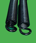 Heavy Hitting Extension Springs Pair Featuring Rock Solid High Tension Steel Construction With 8.5mm Wire Diameter And Secure End Hooks For Hardworking Garage Upgrades close-up view of black steel coils.