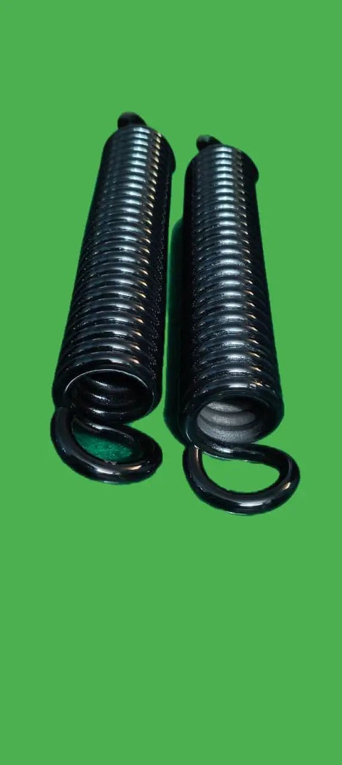 Heavy Hitting Extension Springs Pair Featuring Rock Solid High Tension Steel Construction With 8.5mm Wire Diameter And Secure End Hooks For Hardworking Garage Upgrades close-up view of black steel coils.
