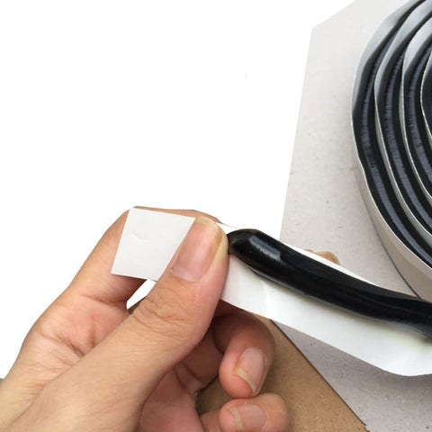 Close-up of Heavy Duty Butyl Sealant Tape for Cars Trucks RVs Boats and Home Projects being unrolled, showing flexibility and texture.