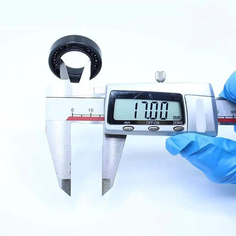 Built Tough Two Piece Thin Section Ball Bearing Set At 17X30X7Mm measuring 17 mm inner diameter with calipers.