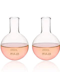 Round Bottom Boiling Flask Set, Two Pack 250ml Each, Borosilicate 3.3 Glass, Short Neck Non Graduated, Heat Resistant Lab Glassware For Prolonged Boiling And Uniform Heating, displaying clear glass design and pink liquid content.