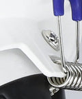 Close-up of a white safety helmet with a blue and silver attachment on the side, showcasing metal and plastic details.