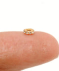 Totally Legit 14k Solid Yellow Gold Pave Diamond 4mm Wheel Spacer Bead on a fingertip for charm bracelets and necklaces.