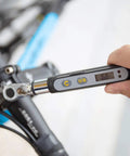 Bit Head Digital Torque Wrench With One Quarter Inch Drive Adapter, Peak Torque Readout On LCD held near bike assembly