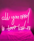 All You Need Is Lashes LED Neon Light Sign Pink 20 Inch for Wall Decor displaying luminous pink text on wall.