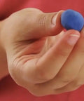Person holding a blue beeswax earplug for deep sleep and snoring reduction so you sleep like a boss with custom molded fit soft and pliable