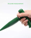Hand holding green ergonomic grip from Six Pack Seed Sowing Dispenser Set with Adjustable Garden Hand Planter Seeder Tool for Flowers and Veggies