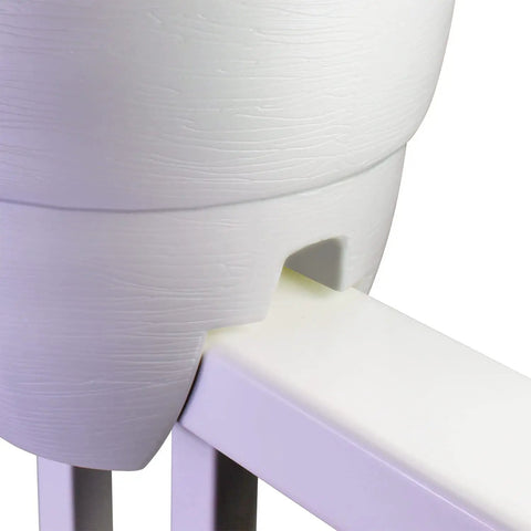 Side view of white railing planter with drainage holes installed on metal rail, fits wood or metal rails 1.25-3.875 inches wide.