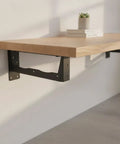Hidden Steel Shelf Brackets For Wall Mounted Desks And Shelves With Matte Black Finish concealed beneath wooden shelf.