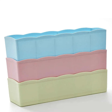 Stackable Plastic Drawer Organizers In Snazzy Pink For Crushing Closet Clutter And Laid Back Home Storage Setup. Three colorful bins.