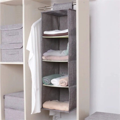 Kick Up Your Closet Game With This Slick Hanging Wardrobe Organizer Featuring A Spacious Mezzanine Drawer And Multi Pocket Portable Rack In Beige For Straight Up Simple Home Storage, showcasing a beige hanging organizer filled with neatly folded linens.