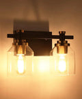 Slick Two Light Industrial Style Bathroom Vanity Light With Clear Glass Shades Matte Black Finish And Brushed Bronze Copper Accent Sockets E26 Bulb Compatible Non Dimmable Fixture Modern Wall Mount Bath Lighting lit view