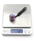 4300KV 1506 Brushless Motor For 4 To 6S FPV Drones Titanium Pink Finish weighing on digital scale