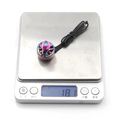 4300KV 1506 Brushless Motor For 4 To 6S FPV Drones Titanium Pink Finish weighing on digital scale