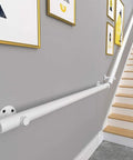 Straight Shooting Matte Black Pipe Handrail With Vintage Industrial Look And Rock Solid Wrought Iron Frame For Indoor Outdoor Steps Featuring No Sweat Custom Mounting And Durable Slip Resistant Grip installed alongside stairs with wall art.