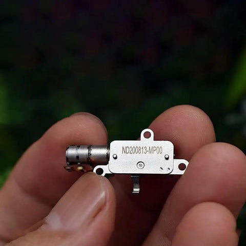 Mini 5mm Stroke Linear Actuator 2 Phase 4 Wire Stepper Motor With Precision Metal Gearbox held in hand, showcasing compact design.