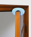Blue silicone door stopper on wooden door from the 3 Pack Silicone Door Stopper Set For Safety Anti Skid Hold Doors Steadily And Prevent Slamming Dope Durable Quiet Operation Great Housewarming Gift For Home Use.