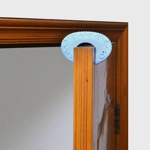 Blue silicone door stopper on wooden door from the 3 Pack Silicone Door Stopper Set For Safety Anti Skid Hold Doors Steadily And Prevent Slamming Dope Durable Quiet Operation Great Housewarming Gift For Home Use.