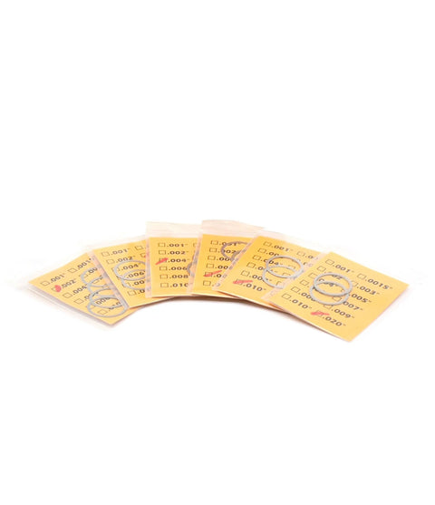 Front view TACSHIM 20-pack barrel shim kit; metal shims on yellow cards for muzzle brake timing, 5/8 x 24, .308/7.62 cal.