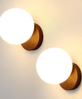 Prosmoon Modern Globe Wall Sconce Set of 2, 3-Color Temperature Adjustable with milk glass shades and walnut bases.